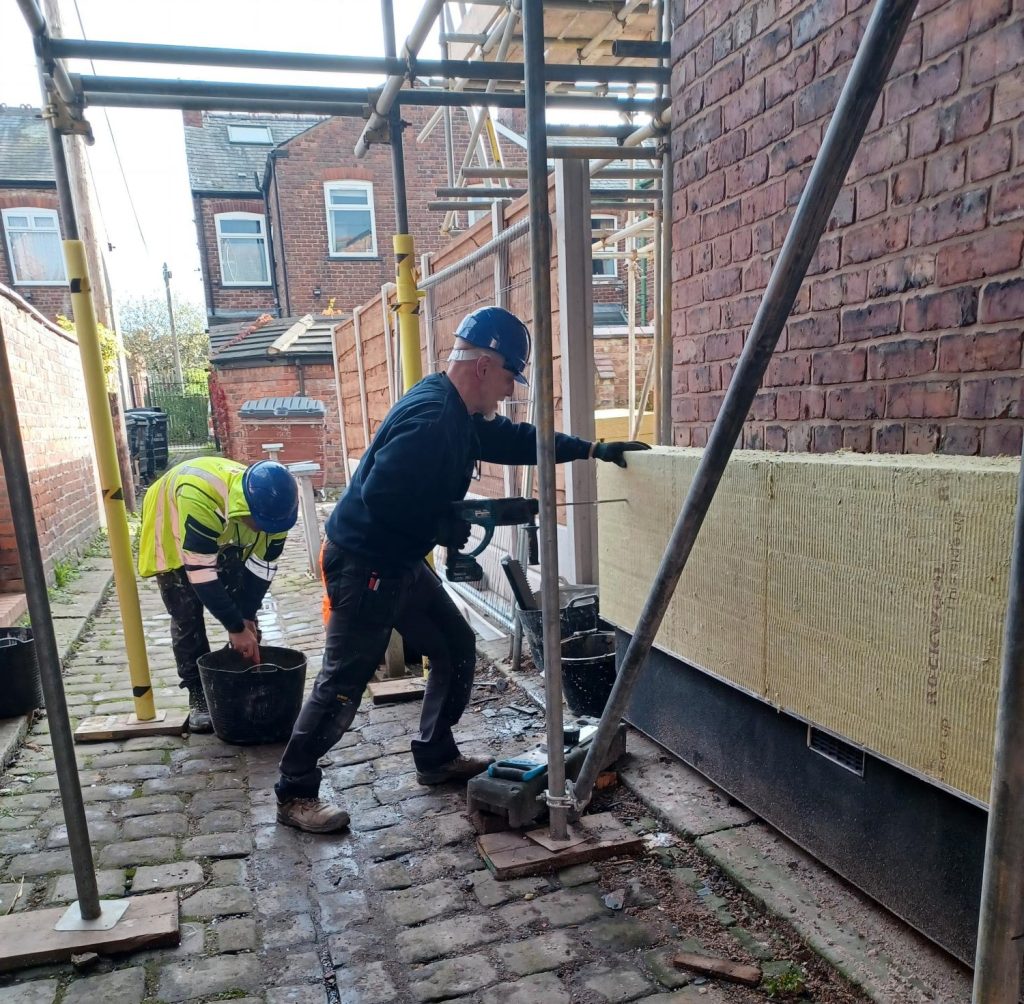 B4Box operatives installing external wall insulation. 